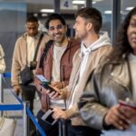 People waiting in line at airport check-in.