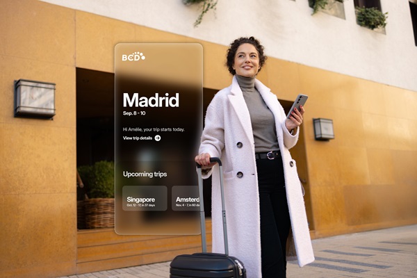 Traveler with suitcase and phone in urban setting.