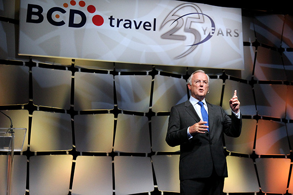 Man speaking at BCD Travel's 25th anniversary event.