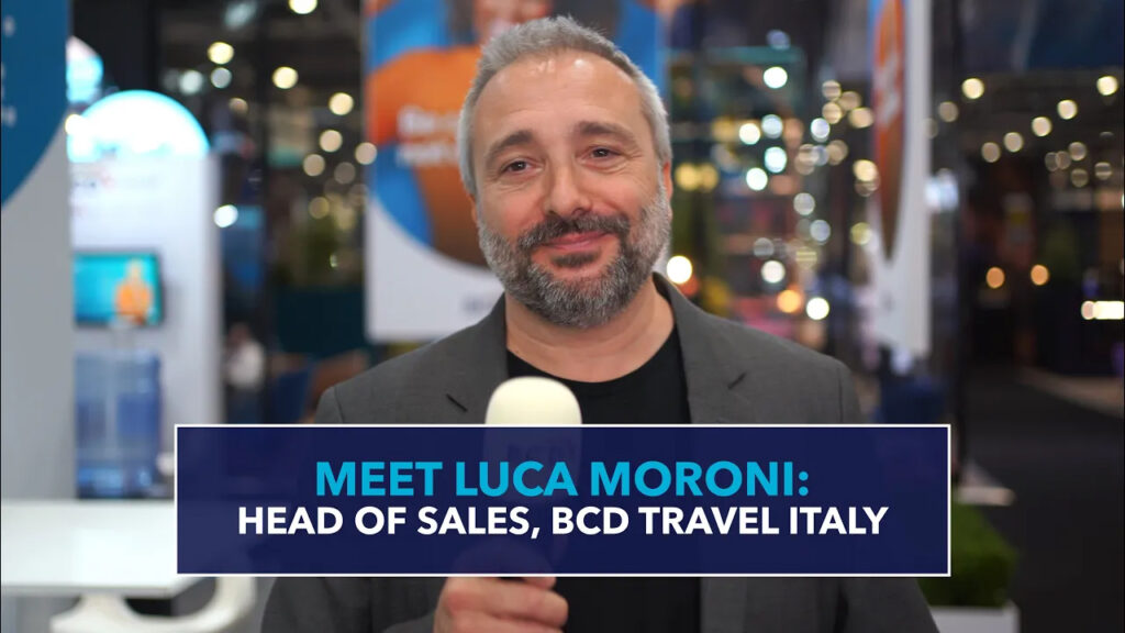 Business professional at travel event, smiling.