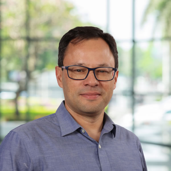 Smiling man wearing glasses in office.