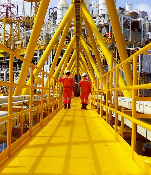 Workers on industrial yellow platform walkway
