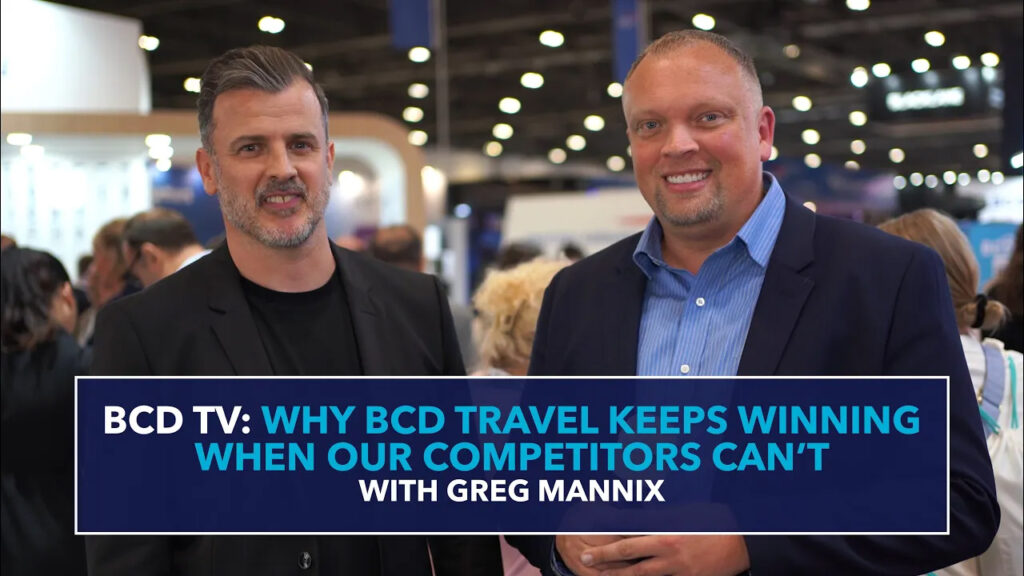 Two men at business event discussion.