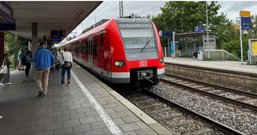 Red train at station platform with passengers